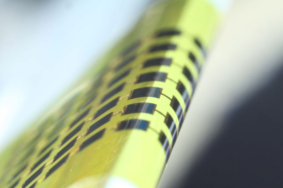 Ultra-thin solar cells are flexible enough to bend around small objects, such as the 1mm-thick edge of a glass slide, as shown here. Credit: Juho Kim, et al/ APL
