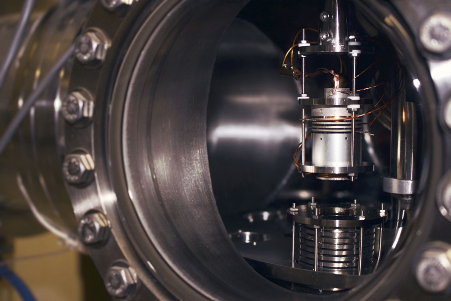 One of many experimental systems for studying LEE-induced damages to condensed biomolecules in the research group of Leon Sanche at the Université de Sherbrooke. In this illustration, we can see a low energy electron gun (top) and a cylindrical multidetector (bottom). This system is used to irradiate (with low energy electrons) short DNA strands condensed onto a cylinder inner surface. The irradiated DNA is afterwards analyzed by HPLC/MS-MS to detect any chemical changes.  CREDIT: Vincent Lemelin, Université de Sherbrooke, Québec, Canada