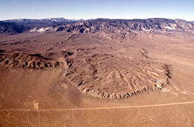 The final deposit of the Blackhawk landslide in Southern California. This landslide originated in the mountains in the background and flowed out many times its initial flow height over near-flat ground. Photo by Kerry Sieh.