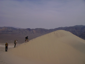 Climbing with heavy field equipment to the top of the 200m-high Eureka Dune in Death Valley National Park, Calif.