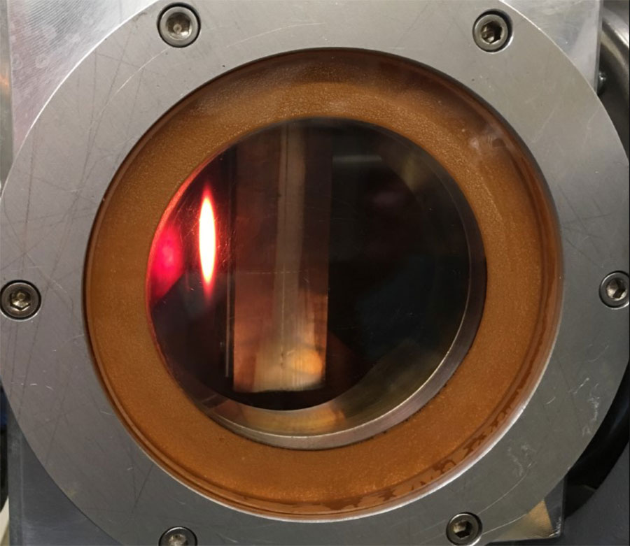 More than 2 kilowatts of proton beam impinging on the water-cooled, tungsten-reinforced beam stop at the end of the ECRIS acceleration column, as seen through its viewing portal. Credit: Arthur E. Champagne 