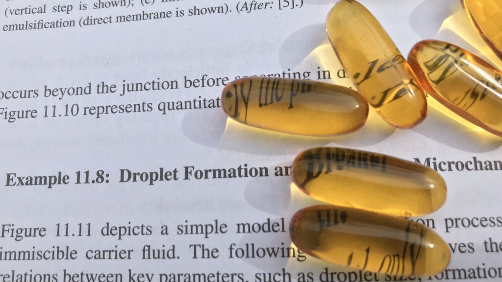 Microfluidic technology is used to miniaturize a fish oil capsule from its normal size to the size of a printed dot in a book. CREDIT: Nam-Trung Nguyen