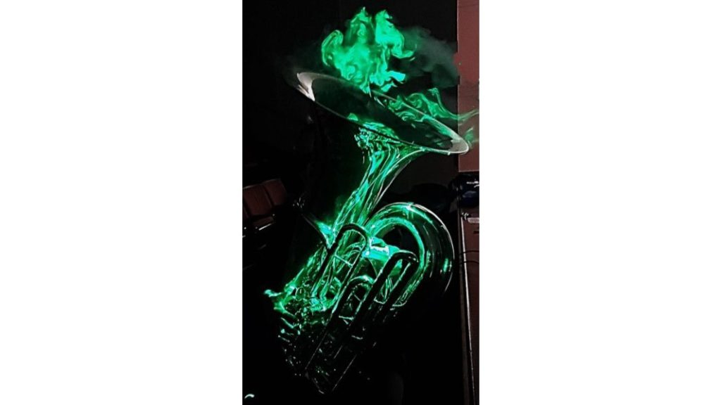 Visualization of flow emanating from a tuba using the laser sheet technique. The image shows a member of The Philadelphia Orchestra, Carol Jantsch, principal tuba player, who took part in the study on aerosol dispersion from musical wind instruments. CREDIT: Paulo E. Arratia