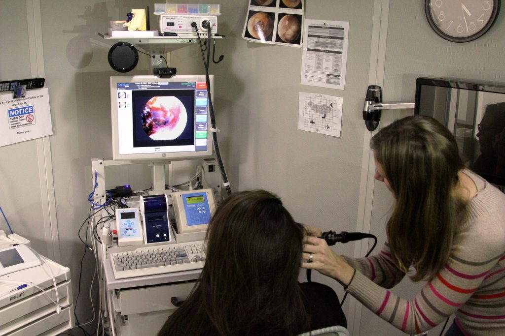 Dr. Samantha Kleindienst Robler taking a photo of an ear (not a patient) using a telemedicine cart. CREDIT: Reba Lean