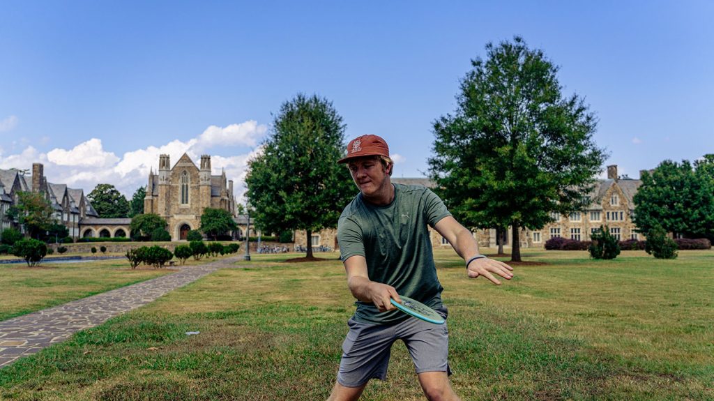 Undergraduate student Calvin Teague demonstrates an optimal thumb grip on a mid-range disc. Credit: Drew Teasley