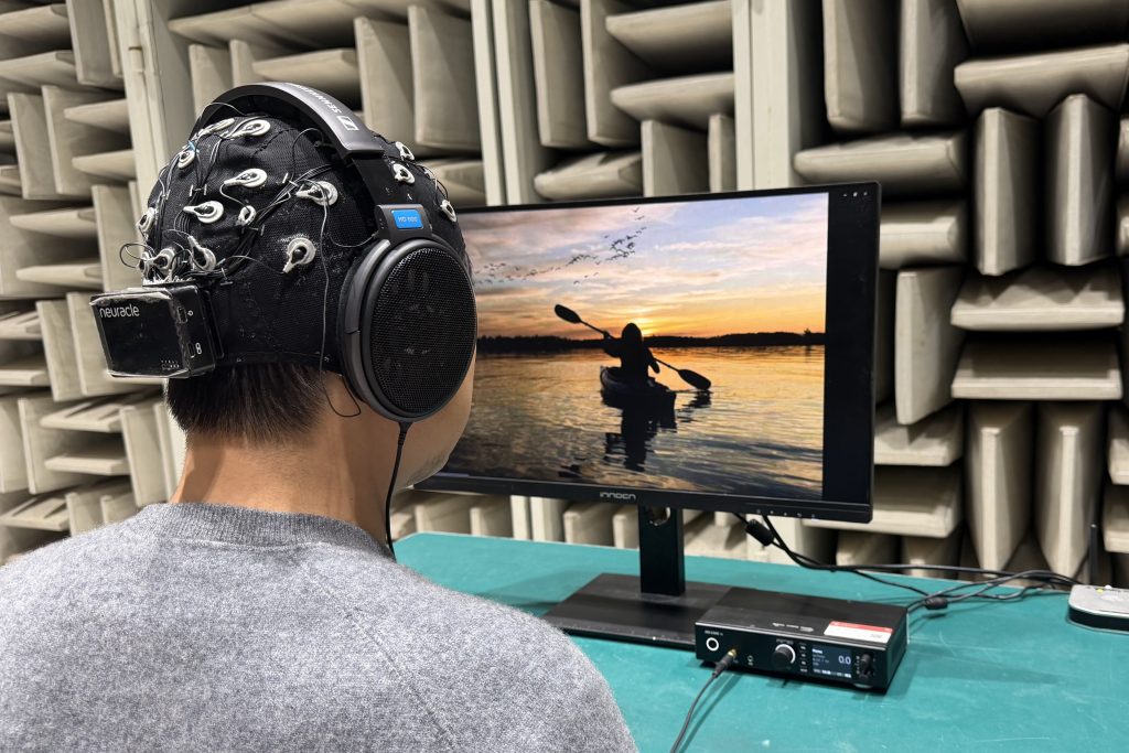 Research participants listened for faint sounds over audio noise. They could hear those sounds much better when they could open their eyes and watch videos or even still photos matching the sounds they were trying to hear. Credit: Yu Huang