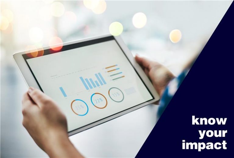 Hands holding a tablet that displays graphs and statistics