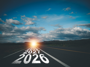 Road leading toward the horizon with years marked on the pavement.